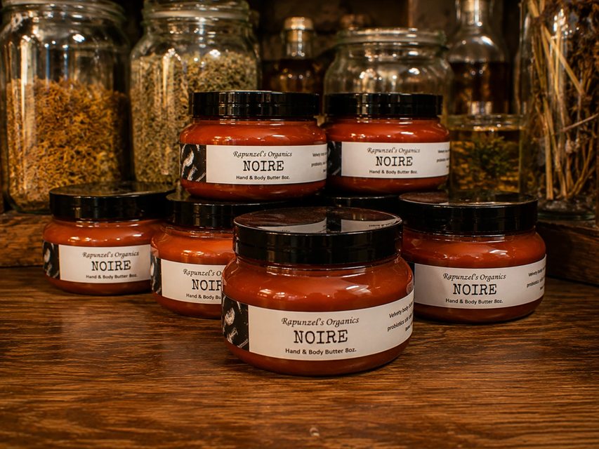 Jars of Noire hand and body butter on a wooden shelf