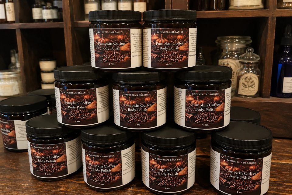 Jars of Pumpkin Coffee body polish stacked in a pyramid